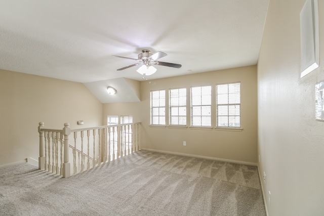 interior space featuring carpet flooring, ceiling fan, and vaulted ceiling