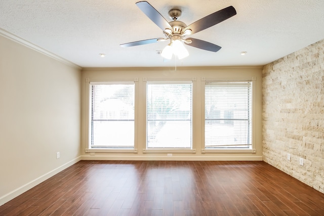 empty room featuring a textured ceiling, crown molding, ceiling fan, and dark hardwood / wood-style flooring