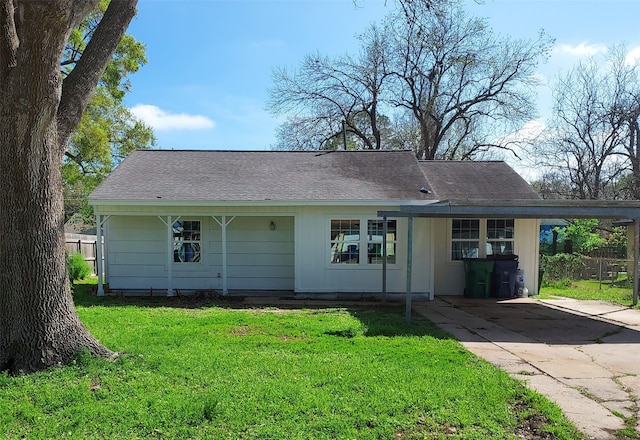 ranch-style home featuring a carport and a front yard