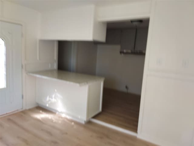 kitchen featuring white cabinetry and light hardwood / wood-style flooring