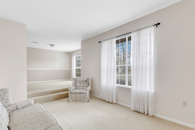 sitting room featuring light colored carpet