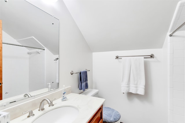 bathroom with vanity, toilet, walk in shower, and lofted ceiling