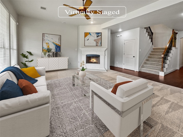 living room with ceiling fan and dark hardwood / wood-style flooring