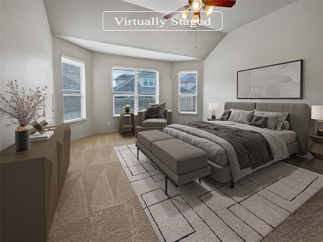 carpeted bedroom featuring ceiling fan and vaulted ceiling