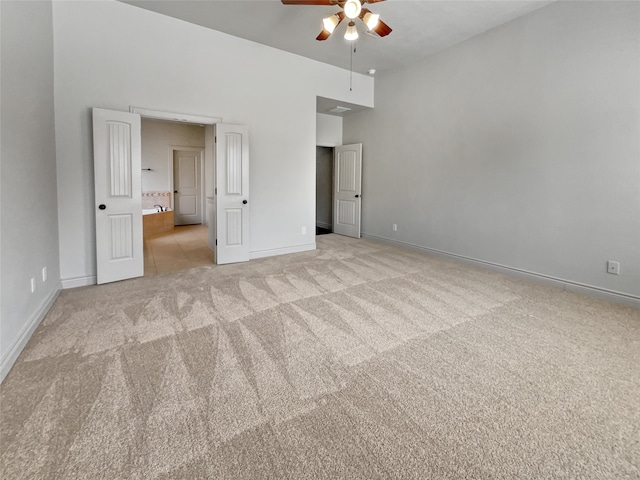 unfurnished bedroom featuring light colored carpet and ceiling fan