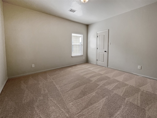 unfurnished room featuring light carpet