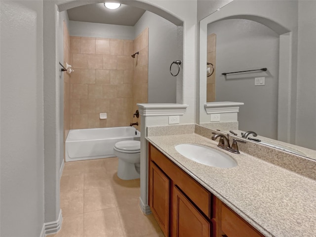 full bathroom featuring toilet, large vanity, tile floors, and tiled shower / bath combo