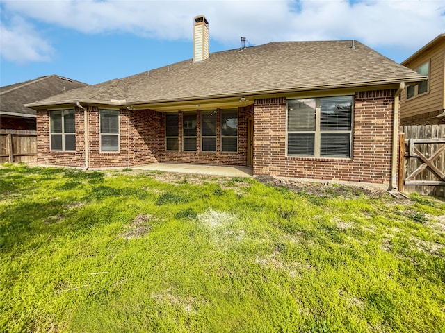 rear view of house featuring a patio area and a lawn