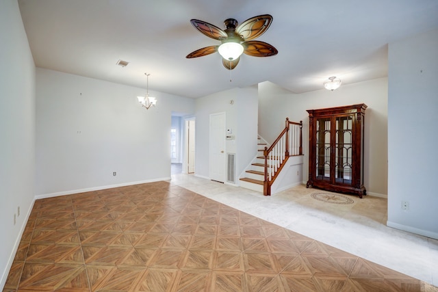 unfurnished room featuring ceiling fan with notable chandelier and light parquet floors