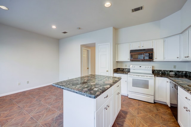 kitchen featuring dark stone counters, a kitchen island, white cabinets, parquet floors, and white electric range