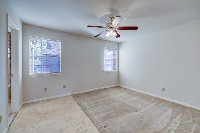 unfurnished room with light tile floors and ceiling fan