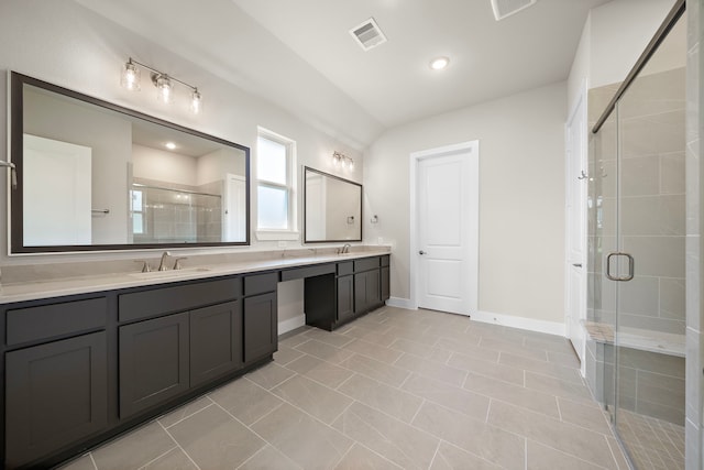 bathroom with lofted ceiling, tile patterned floors, a shower with door, and vanity