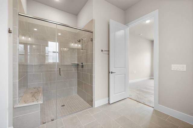 bathroom with tile patterned flooring and a shower with door