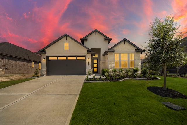 view of front of house featuring a yard and a garage