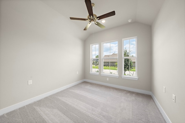 unfurnished room featuring lofted ceiling, carpet flooring, and ceiling fan