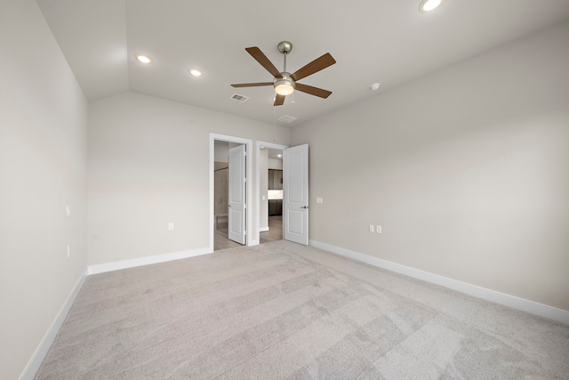 unfurnished bedroom with light carpet, lofted ceiling, and ceiling fan