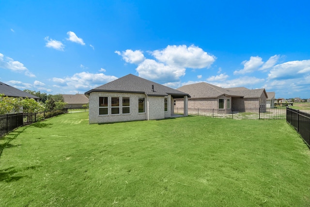 back of house with a lawn