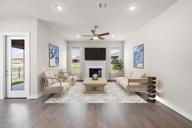 living room with hardwood / wood-style flooring, ceiling fan, and plenty of natural light