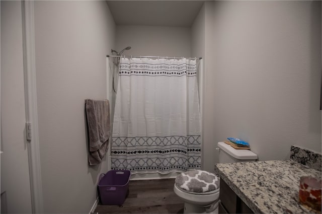 bathroom with a shower with curtain, vanity, toilet, and hardwood / wood-style flooring