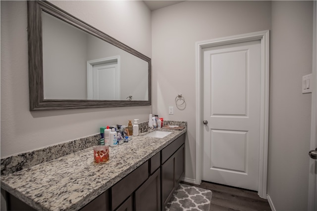 bathroom featuring vanity and hardwood / wood-style flooring