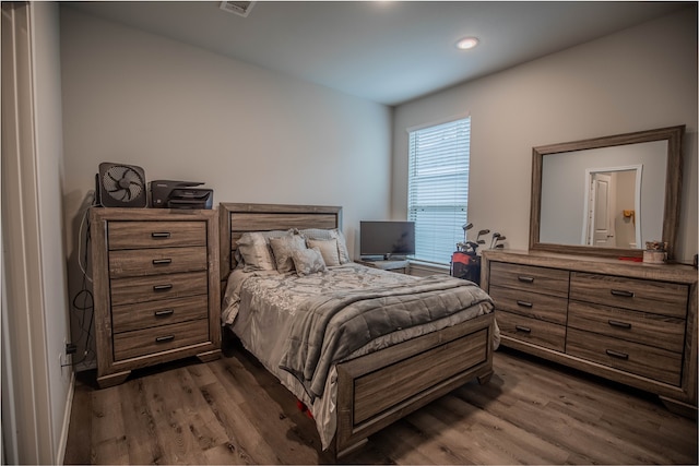 bedroom with dark hardwood / wood-style flooring