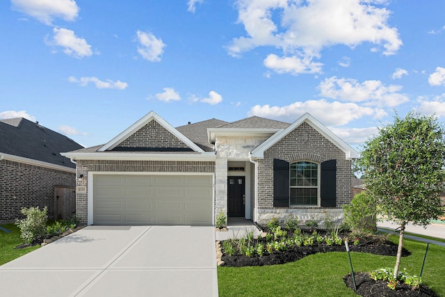 view of front of property with a front lawn and a garage