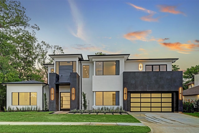 modern home with a lawn and a garage