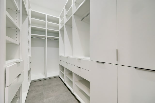 spacious closet featuring light tile floors