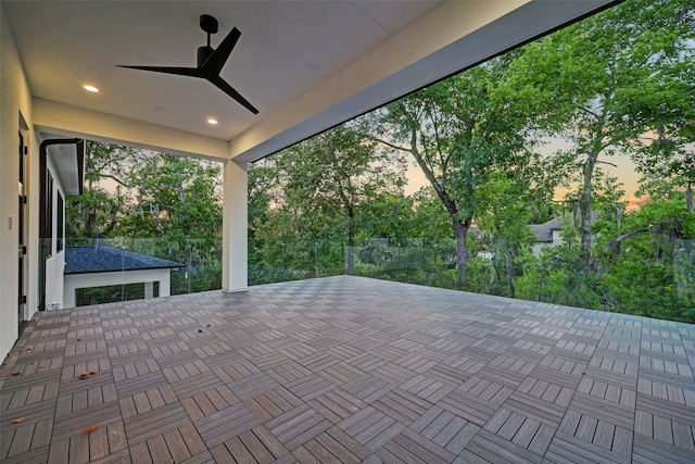 patio terrace at dusk featuring ceiling fan