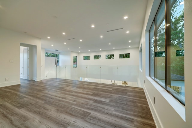 spare room with plenty of natural light and dark wood-type flooring