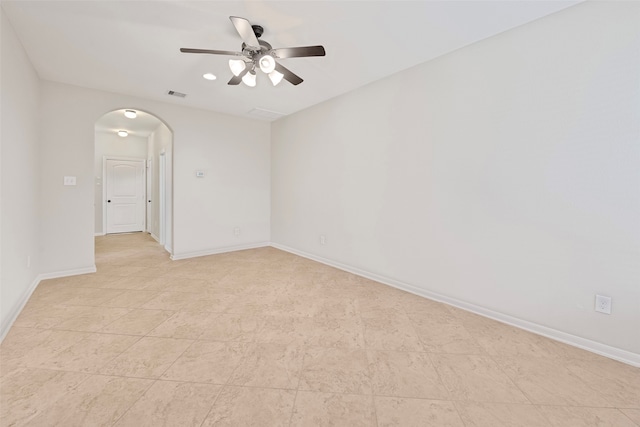 tiled spare room featuring ceiling fan