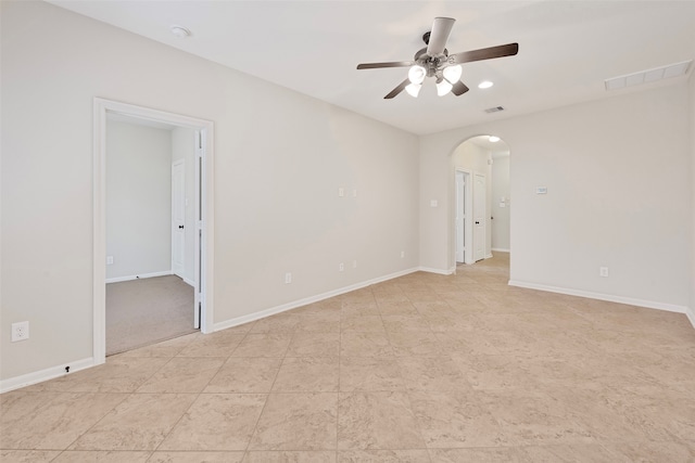 tiled empty room with ceiling fan