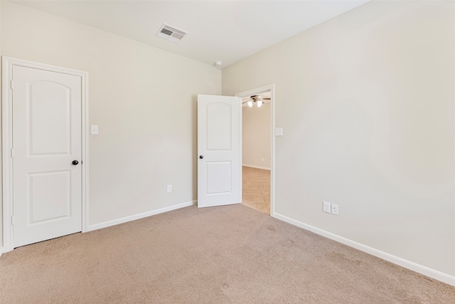 carpeted empty room with ceiling fan