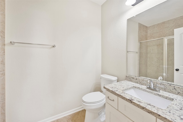 bathroom with tile flooring, toilet, and vanity