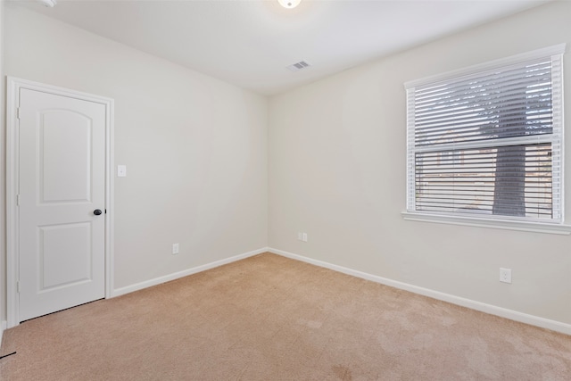 spare room with light colored carpet