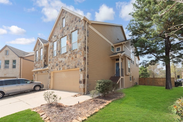 view of front of home featuring a front yard and a garage