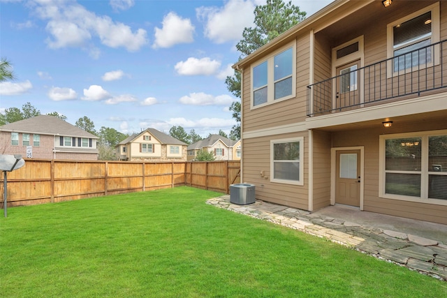 view of yard with central air condition unit, a balcony, and a patio area