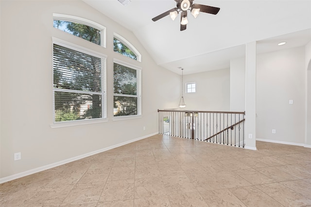 tiled empty room featuring high vaulted ceiling and ceiling fan