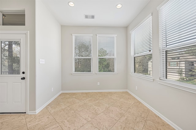 unfurnished room with light tile flooring