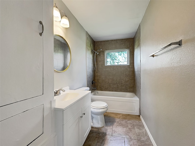 full bathroom with tile floors, vanity, toilet, and tiled shower / bath