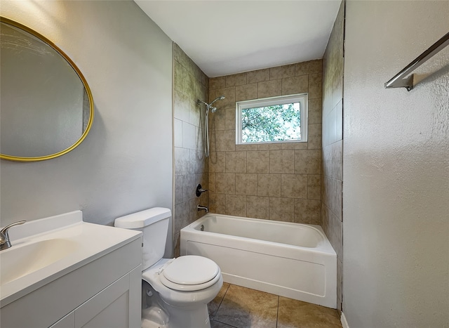 full bathroom with toilet, tile flooring, tiled shower / bath combo, and vanity