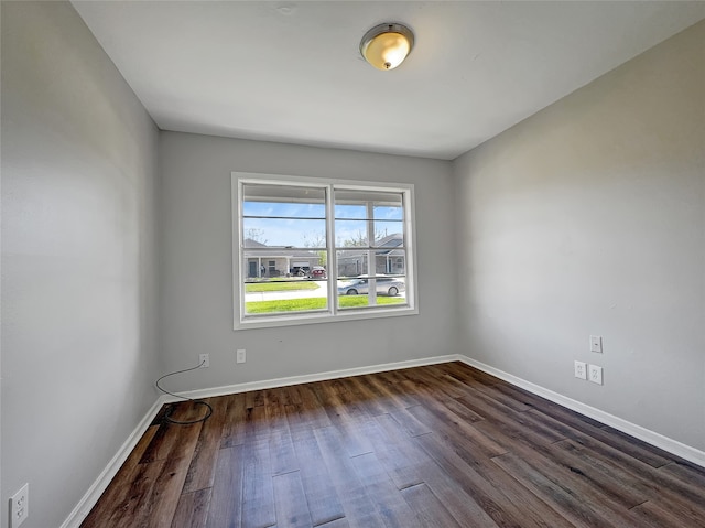 spare room with dark hardwood / wood-style floors