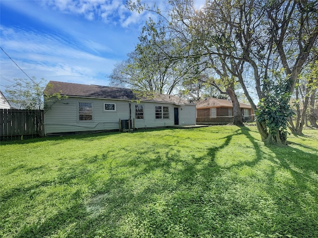 rear view of house featuring a yard