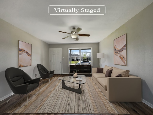 living room featuring ceiling fan and hardwood / wood-style flooring