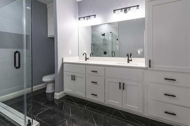 bathroom with vanity, an enclosed shower, and toilet