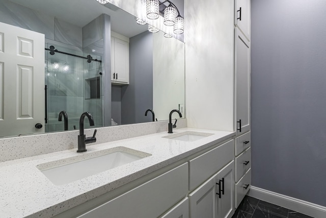 bathroom with vanity and a shower with door