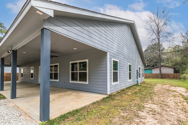 view of side of home featuring a patio and ceiling fan