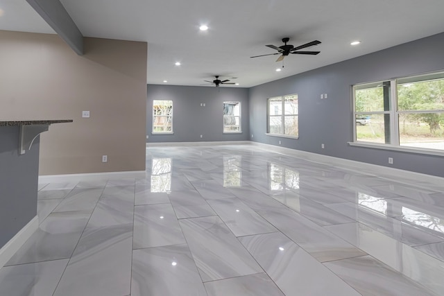 unfurnished living room featuring ceiling fan