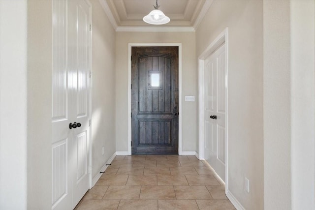 entryway with crown molding and light tile patterned floors