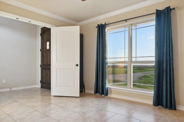 empty room with light tile patterned floors, crown molding, and a healthy amount of sunlight